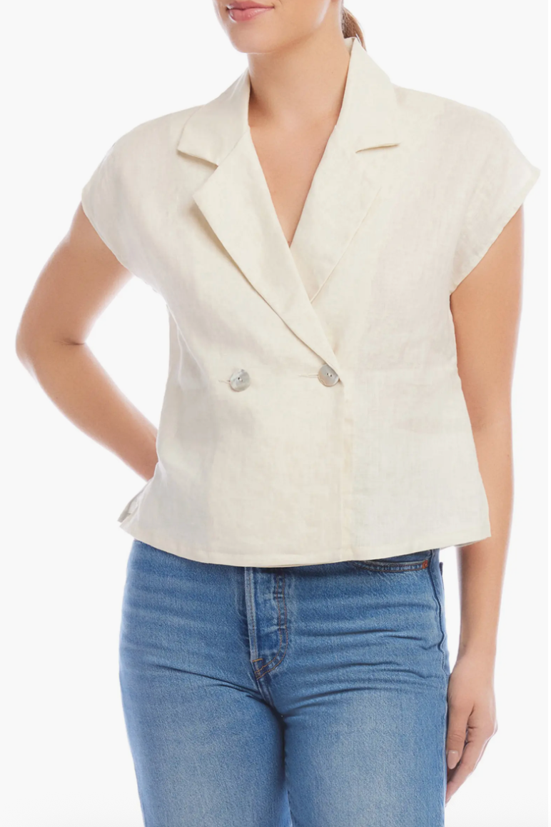 Woman wearing a white blazer over a blue top on a white background