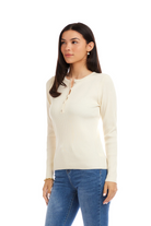 Woman wearing a cream long-sleeve shirt and blue jeans on a white background