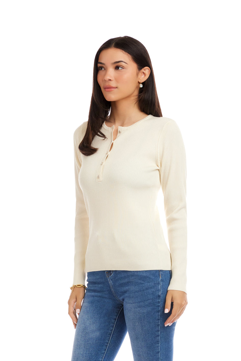 Woman wearing a cream long-sleeve shirt and blue jeans on a white background