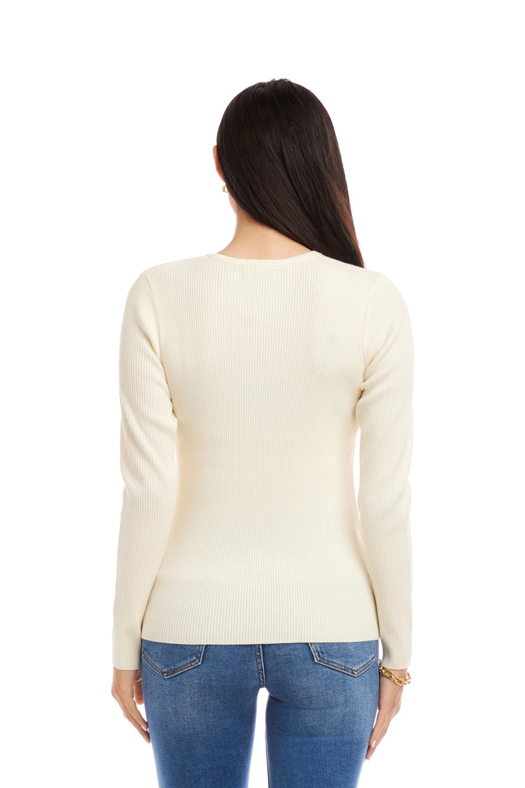 Woman wearing a cream sweater and blue jeans on a white background