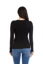 Woman wearing a black long-sleeve top and blue jeans on a white background