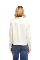 Person wearing a white shirt and blue jeans on a white background