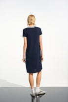 Woman wearing a navy blue dress on a white background