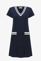 Navy dress with white accents on a white background