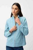 Woman wearing a light blue textured jacket on a white background