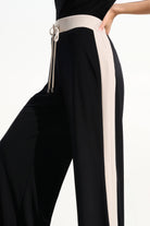 Black pants with a white stripe and drawstring on a white background