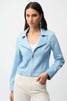 Woman wearing a light blue jacket on a white background