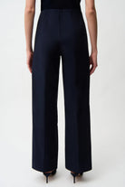 Navy blue wide-leg pants worn by a person on a white background