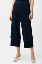 Navy blue wide-leg pants worn by a person on a white background