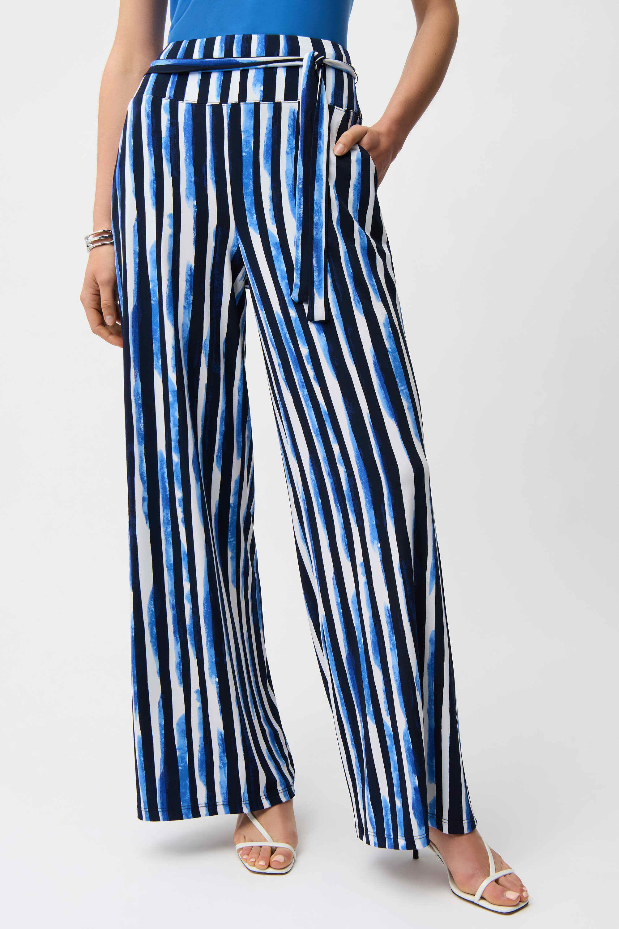 Person wearing blue and white striped pants on a white background