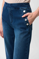 Blue jeans with silver buttons on a white background