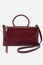 Red handbag with a strap on a white background