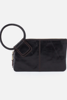 Black clutch bag with a round handle on a white background