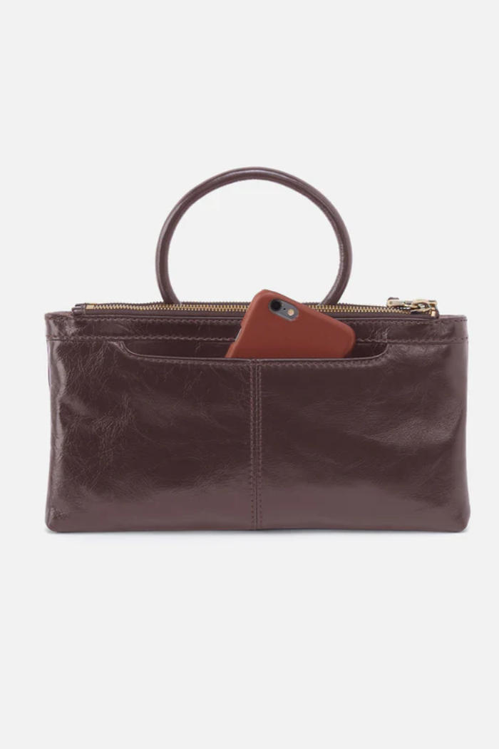 Brown leather handbag with ring handle on a white background