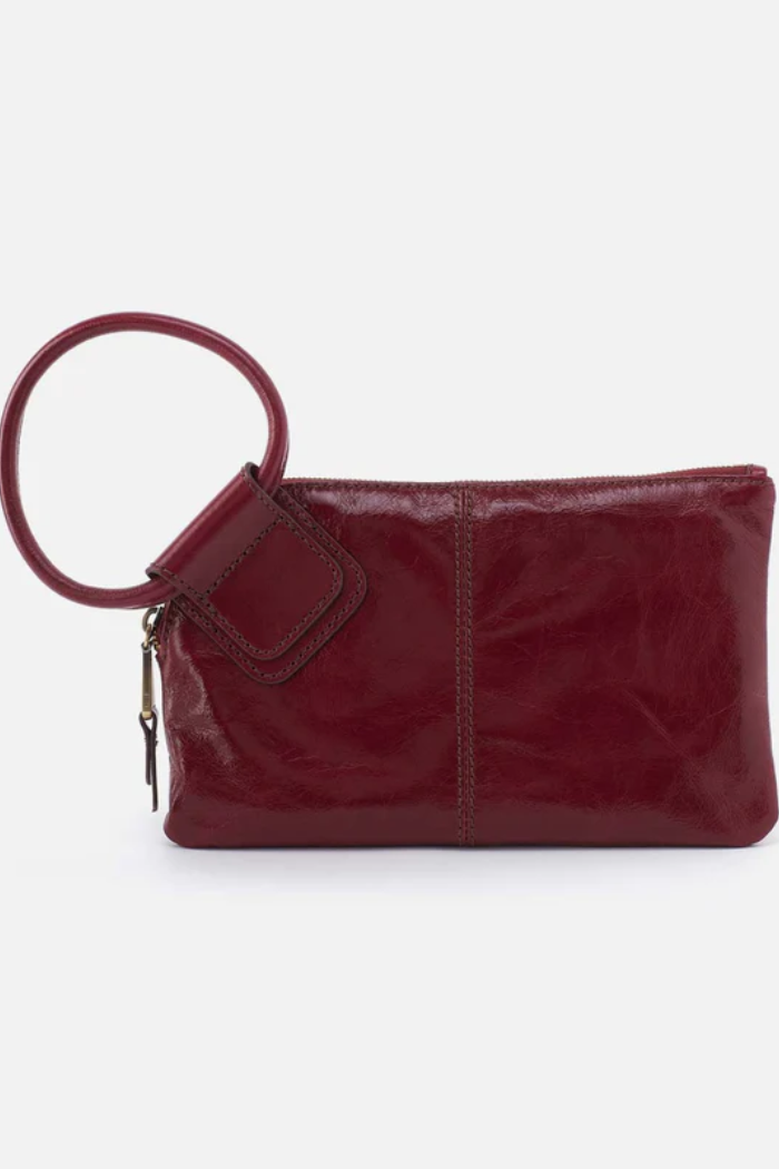 Red leather clutch bag with a handle on a white background