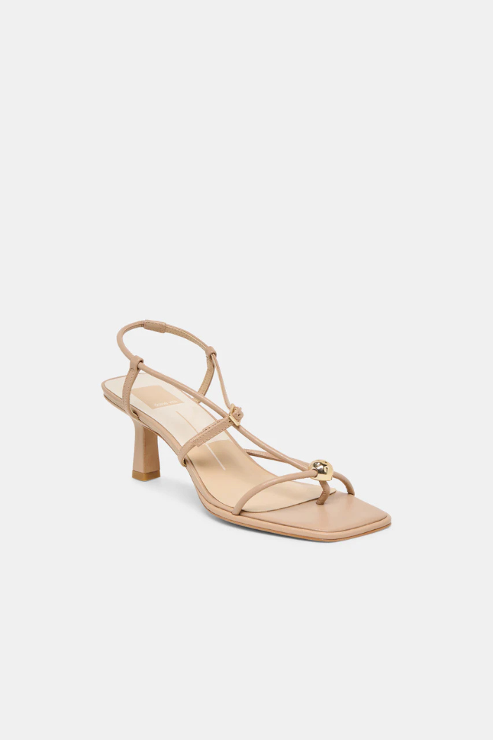 Beige sandal with a block heel on a light beige background