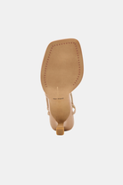 Tan high-heeled shoe on a white background