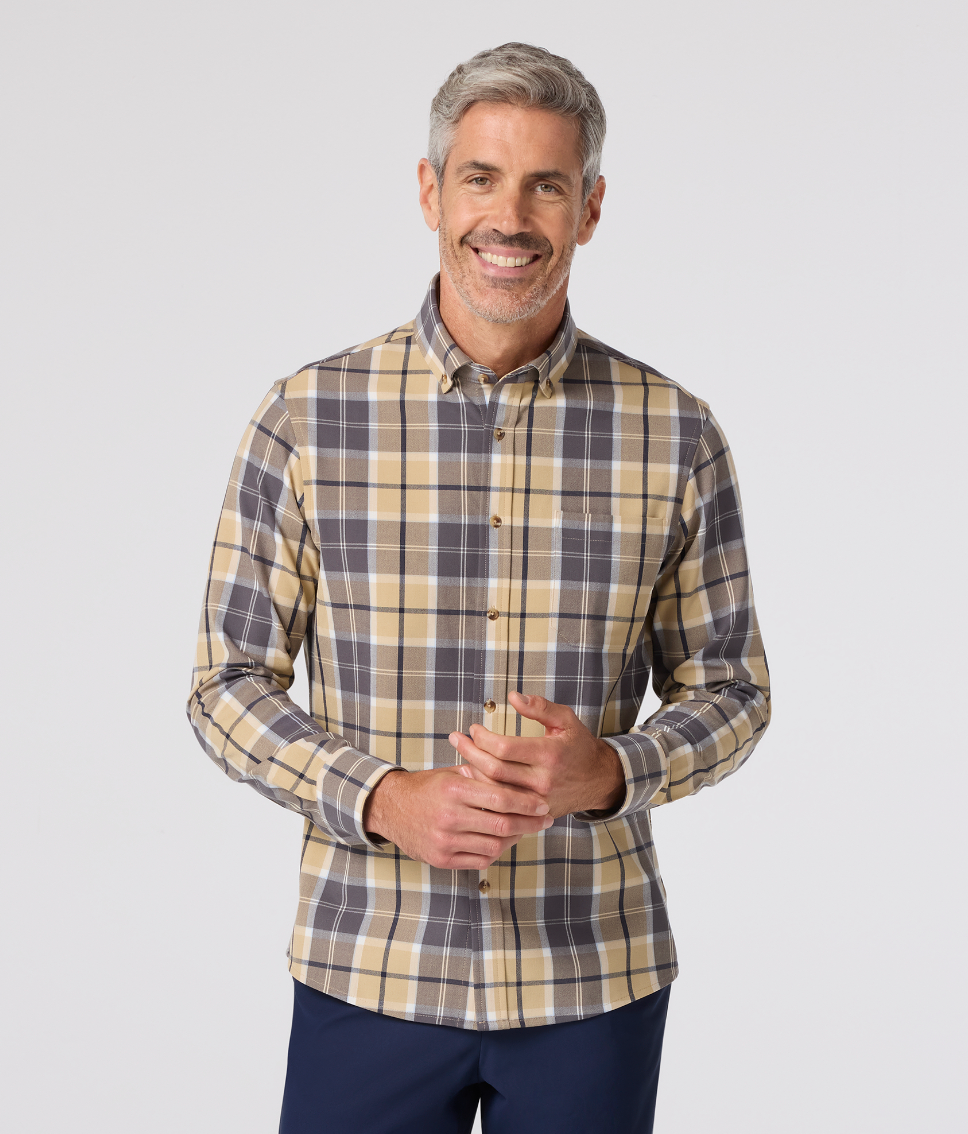 Man wearing a plaid shirt with a plain background