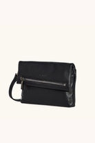 Black leather handbag with a strap on a white background