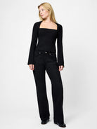 Woman wearing a black outfit on a white background