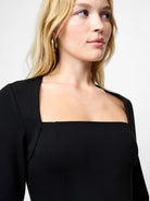 Woman wearing a black top against a white background