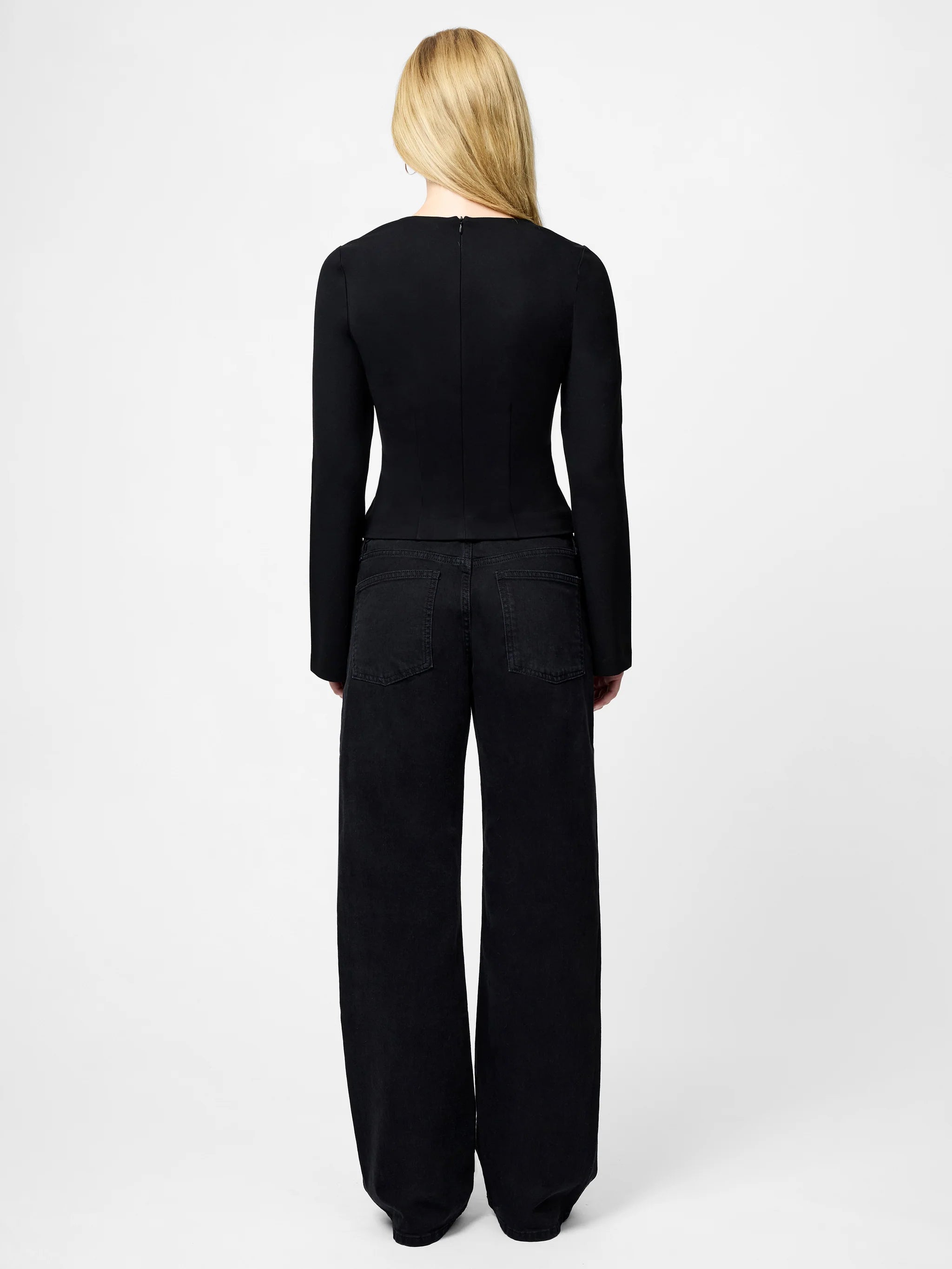 Person wearing a black outfit on a white background