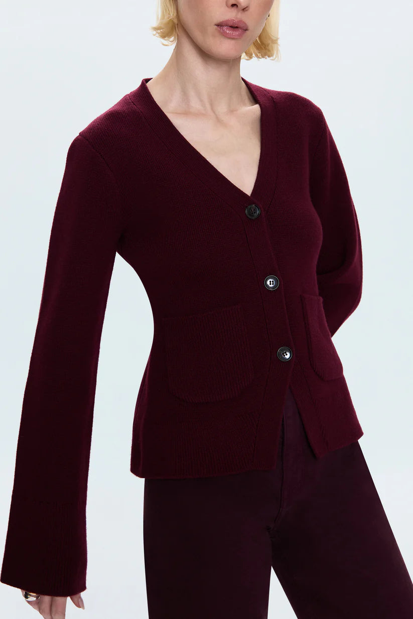 Maroon cardigan and pants on a plain background