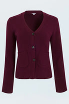 Maroon blazer with button details on a light gray background