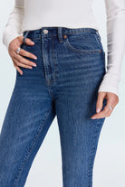 Person wearing blue jeans with a white background