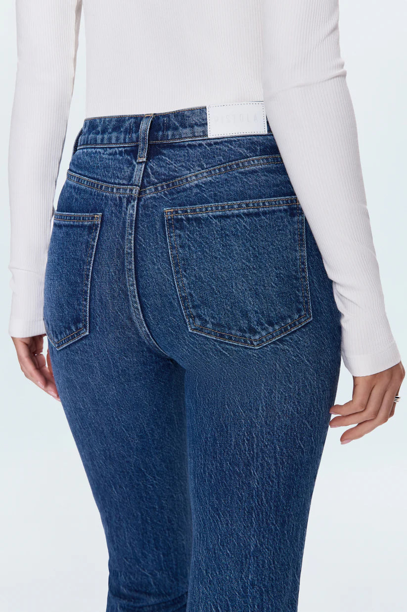 Blue jeans worn by a person on a white background