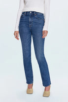 Person wearing blue jeans on a white background