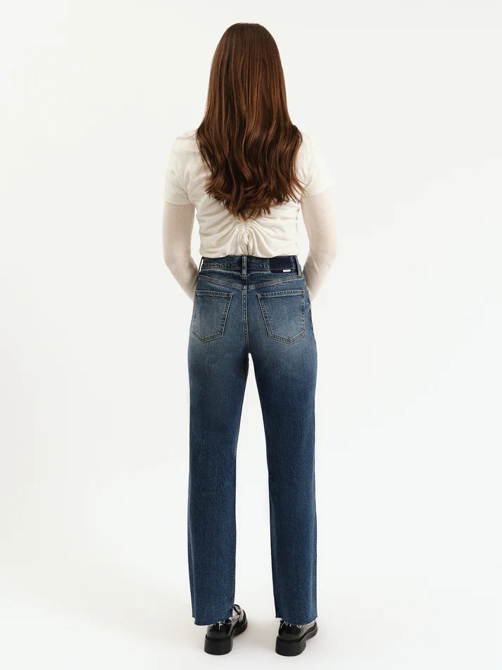Person wearing blue jeans and a white shirt on a white background