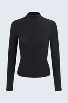 Black long-sleeve top on a light gray background