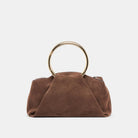 Brown suede handbag with gold ring handle on a white background