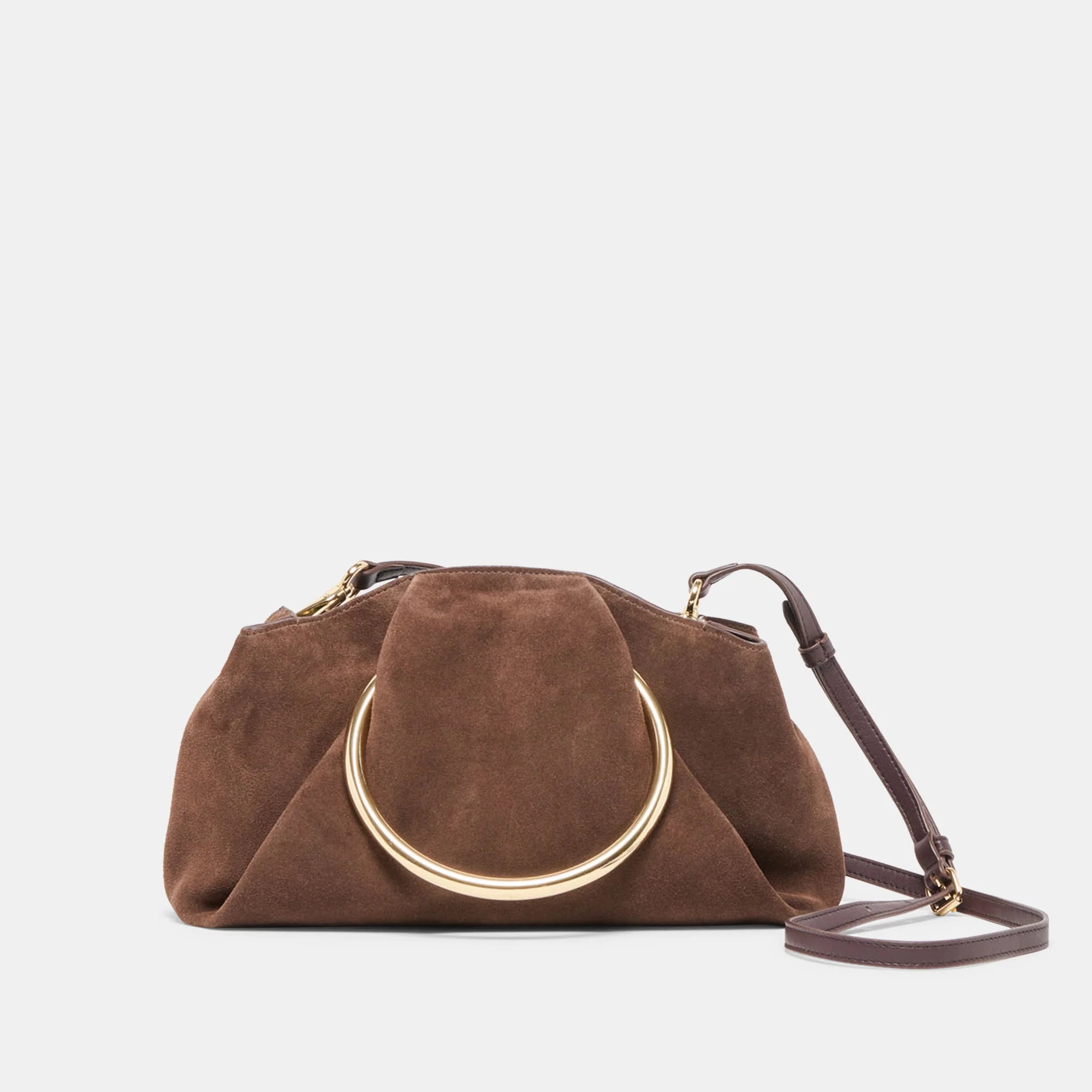 Brown suede handbag with gold circular handle on a light gray background