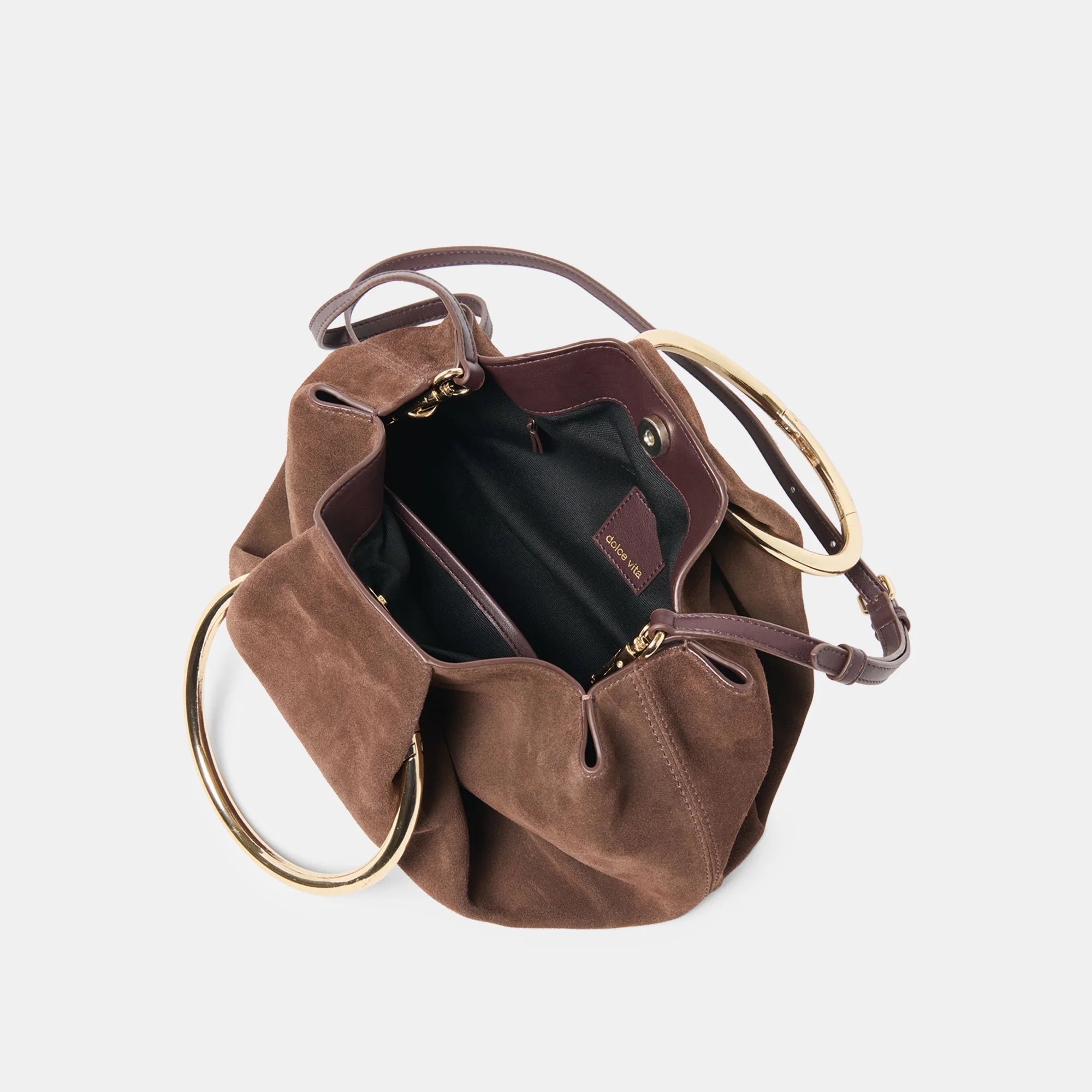 Brown suede handbag with gold circular handles on a light gray background