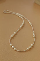 Pearl necklace on a beige background