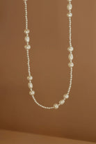Pearl necklace on a brown background