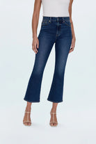 Person wearing blue jeans on a white background