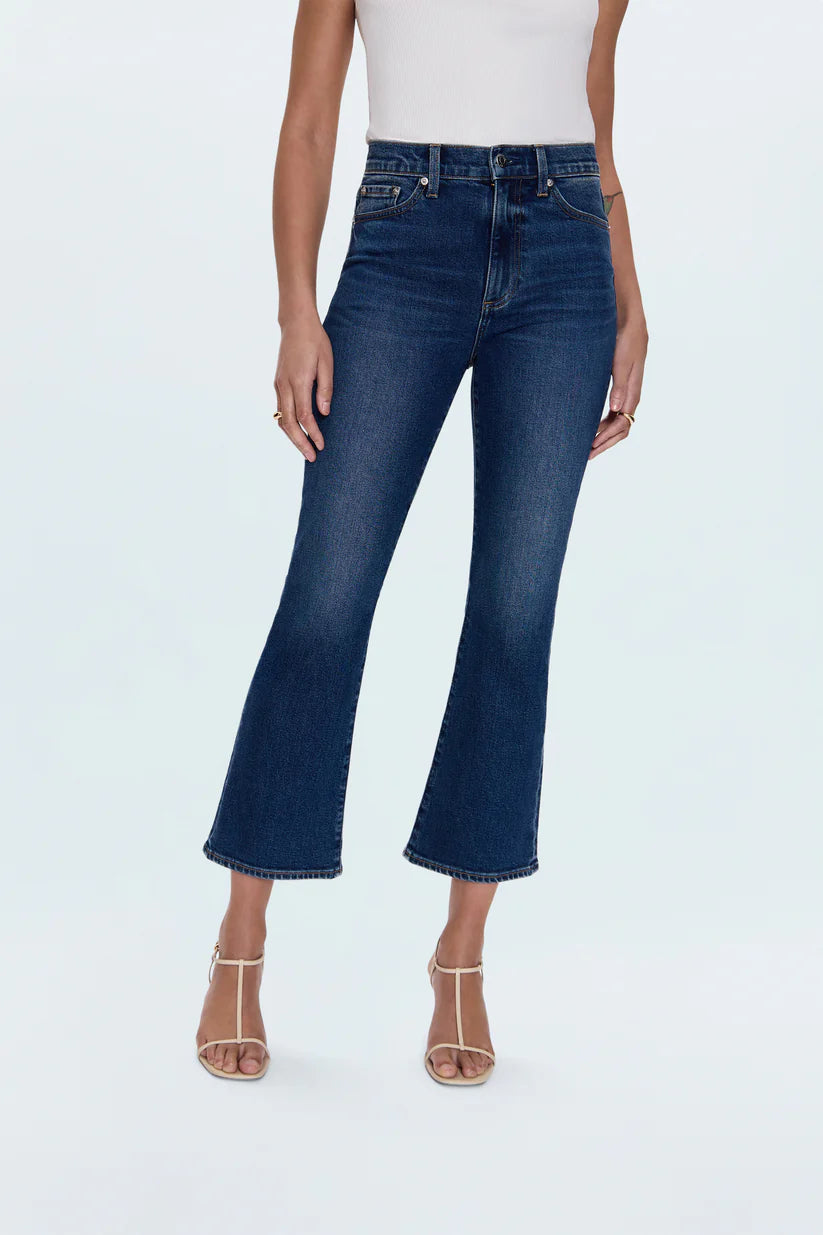 Person wearing blue jeans on a white background