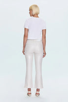 Person wearing a white t-shirt and light-colored pants on a plain background