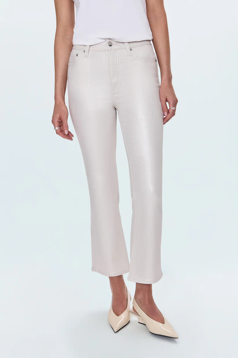 Person wearing white pants and beige shoes on a light blue background