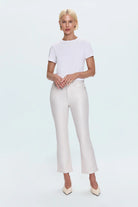 Person wearing a white t-shirt and white pants on a light blue background