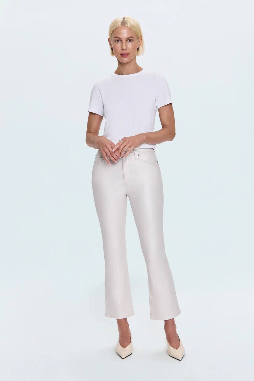 Person wearing a white t-shirt and white pants on a light blue background