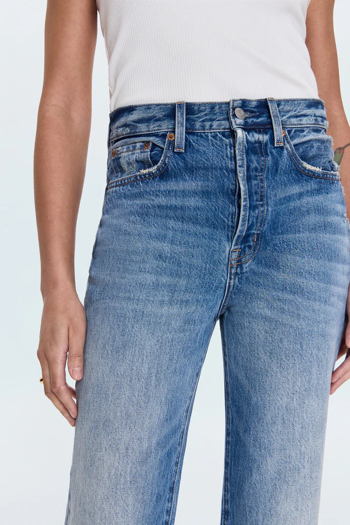 Blue jeans worn by a person on a white background