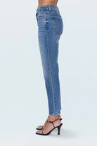 Blue jeans worn by a person on a white background