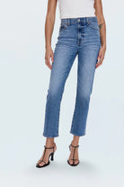Person wearing blue jeans on a white background