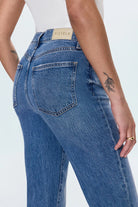 Blue jeans with a visible brand label on a white background