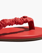 Red sandal with a strap on a white background