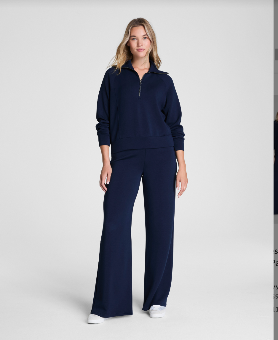 Woman wearing a navy blue outfit on a white background